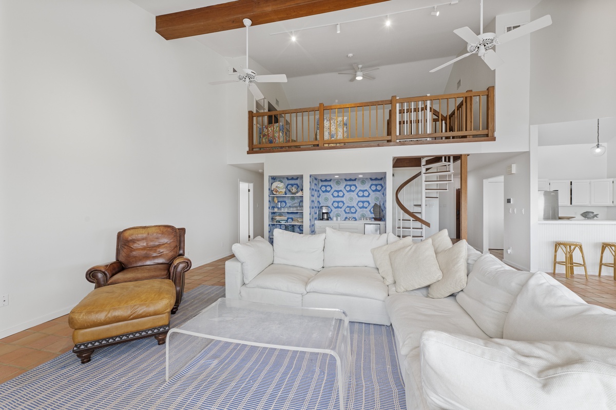 Unwind in your spacious loft with soaring ceilings, cozy leather seating, and a stunning spiral staircase leading to your private upstairs retreat.