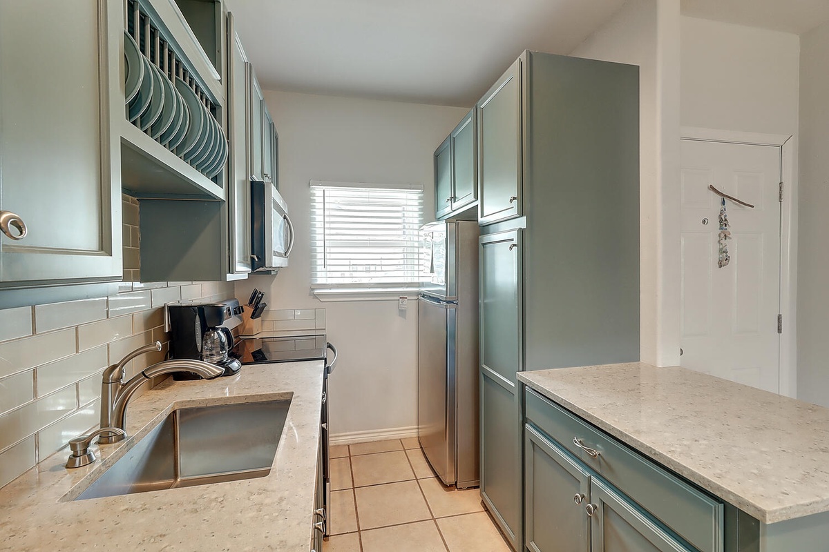 Your fully-equipped kitchen awaits with modern appliances and ample counter space for preparing memorable meals during your stay.