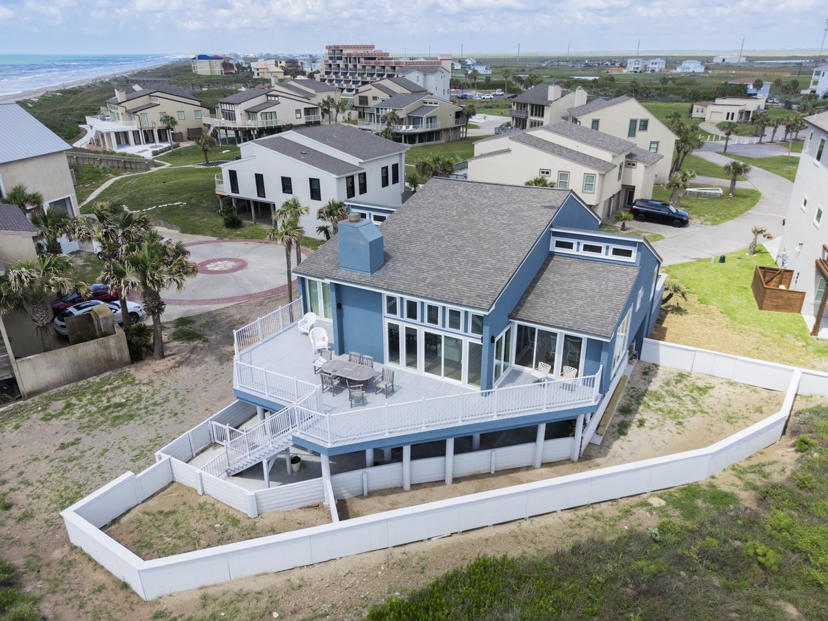 Coastal beach house with wraparound deck and ocean access in a peaceful residential neighborhood.