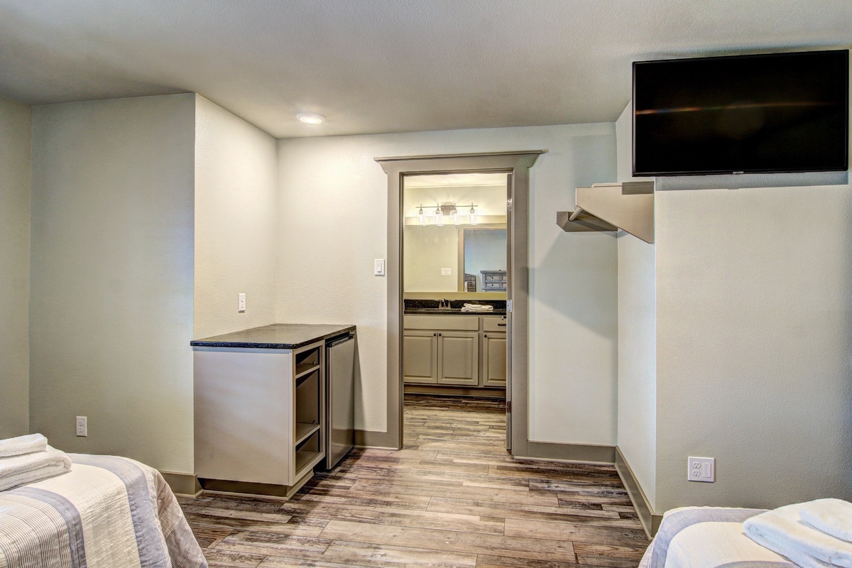 Your suite features a convenient wet bar and connects seamlessly to a full kitchen for easy meal prep.