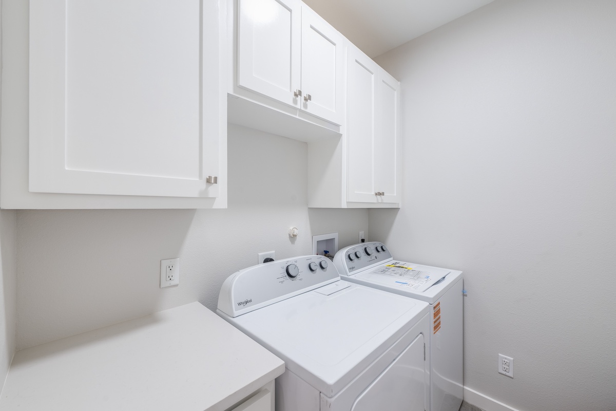 Your dedicated laundry room features a full-size washer and dryer with ample cabinet storage for your convenience.