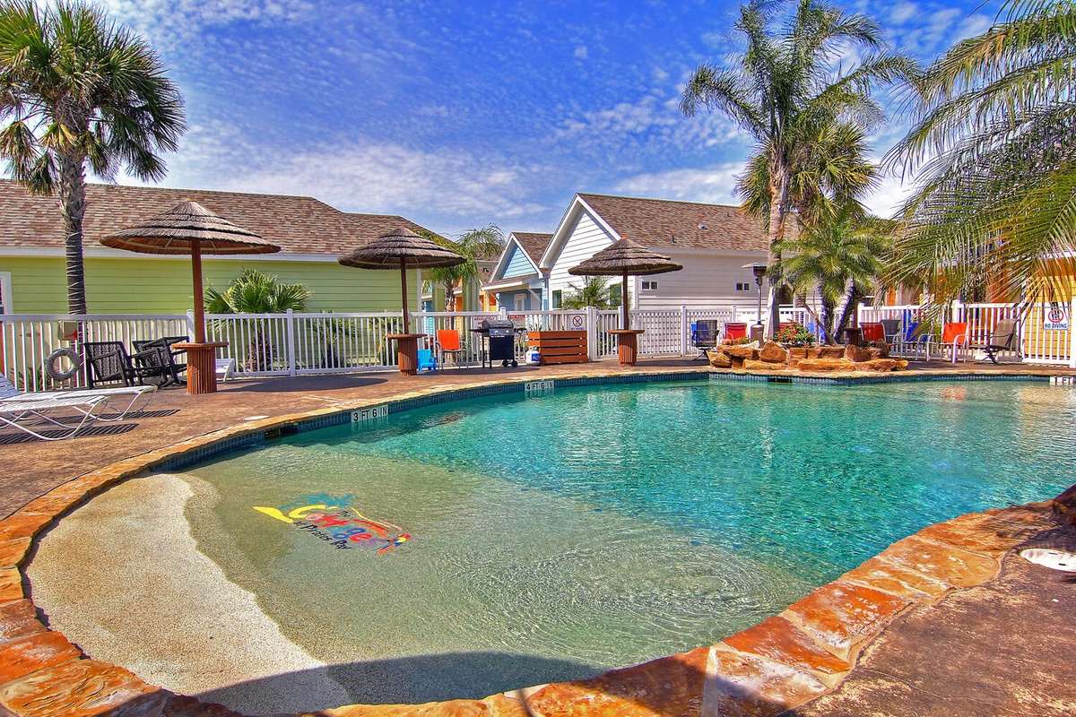 Dive into your private tropical oasis with crystal-clear waters, gentle entry steps, and swaying palms creating the perfect backdrop.
