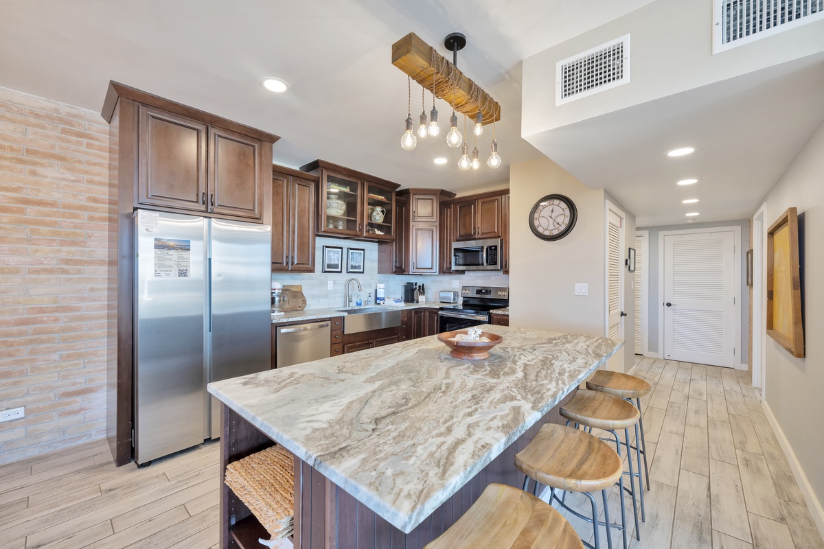 Your spacious kitchen features rich wood cabinetry, granite countertops, and a stunning pendant light fixture perfect for cooking memorable meals.