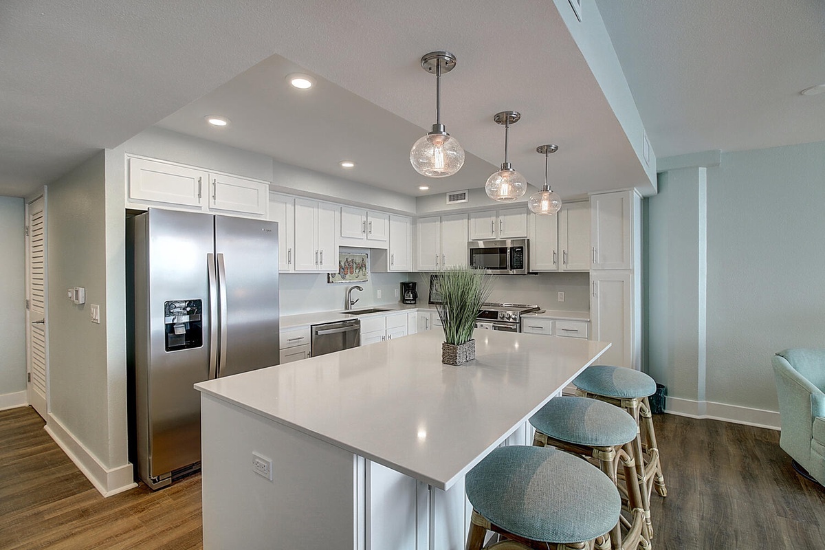 Gather around this stunning white kitchen island where coastal vibes meet modern elegance—perfect for morning coffee or evening conversations.