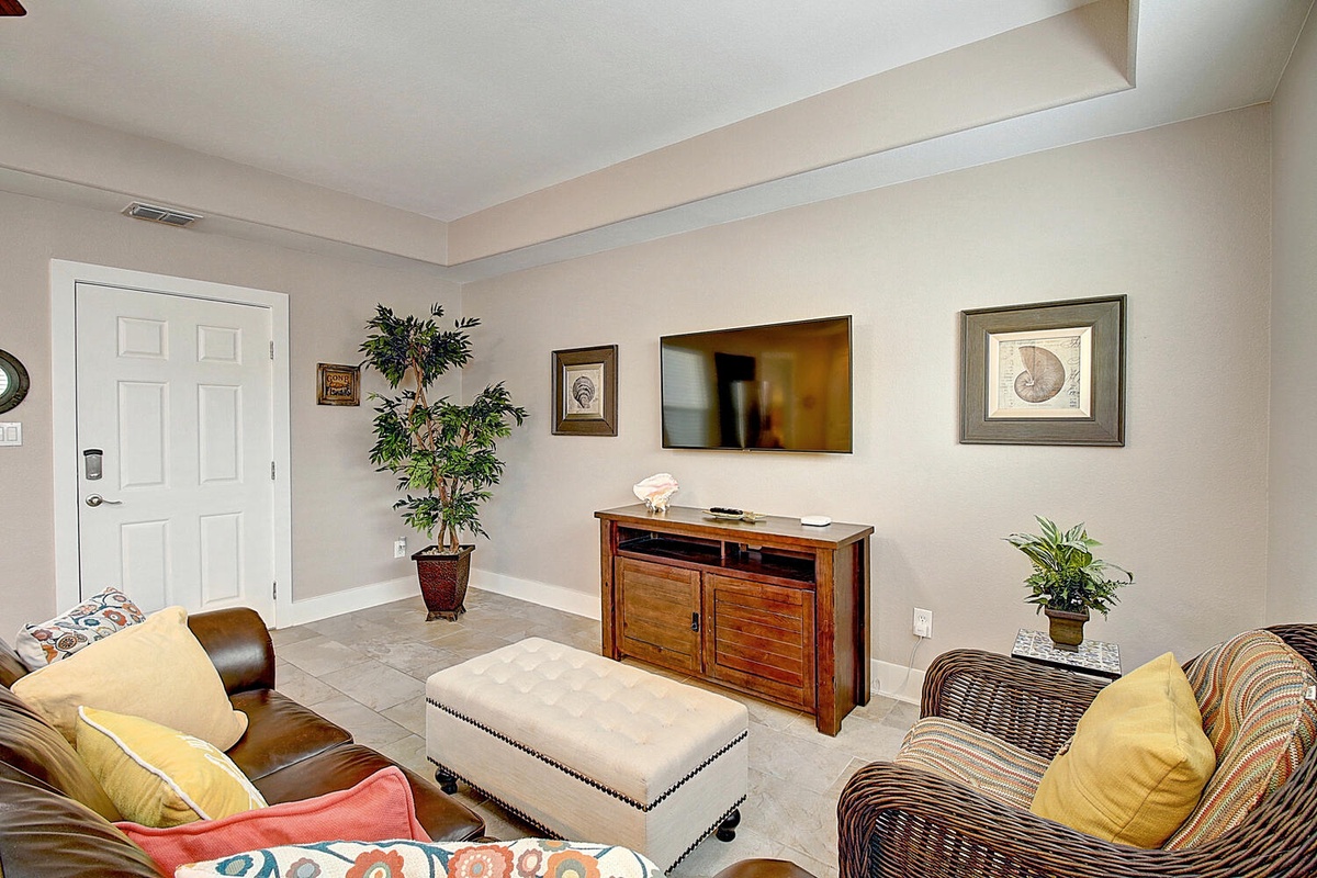 Sink into comfortable seating and enjoy your favorite shows on the wall-mounted TV in this welcoming living space.