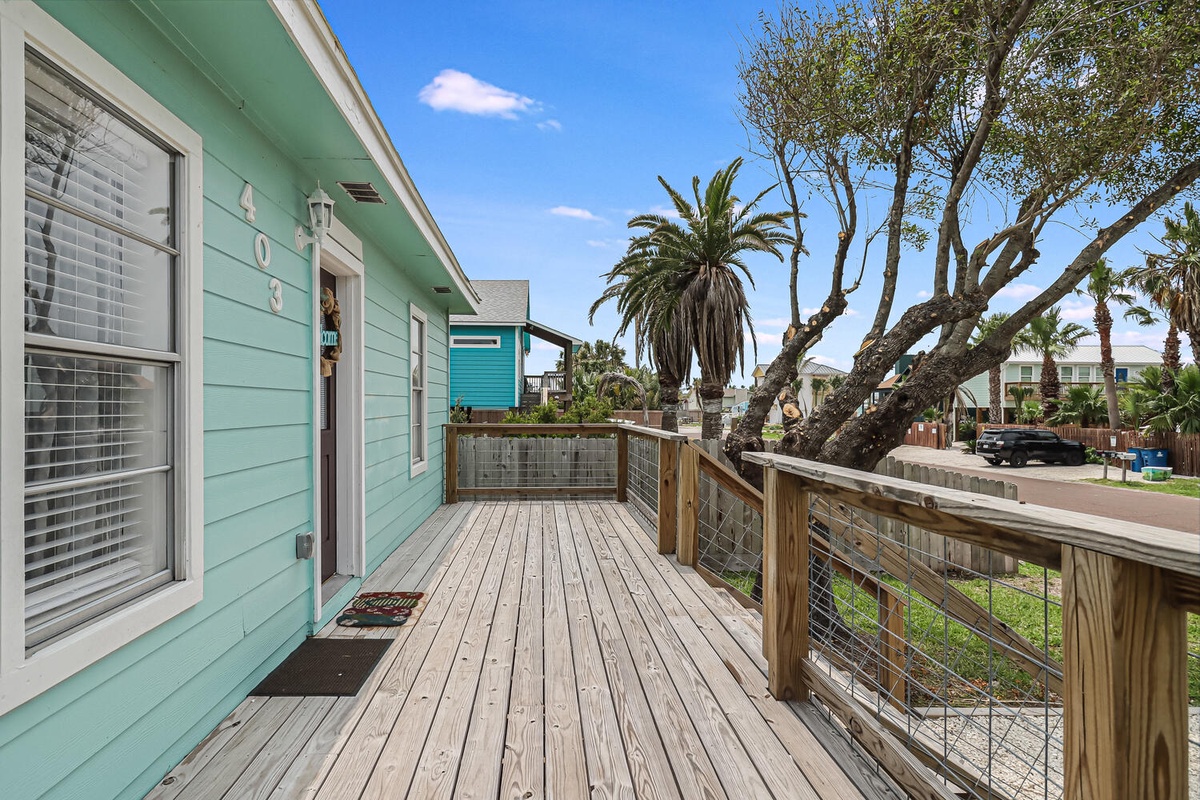 Step onto your private deck surrounded by tropical palms, where coastal breezes and turquoise charm create the perfect beachside retreat.