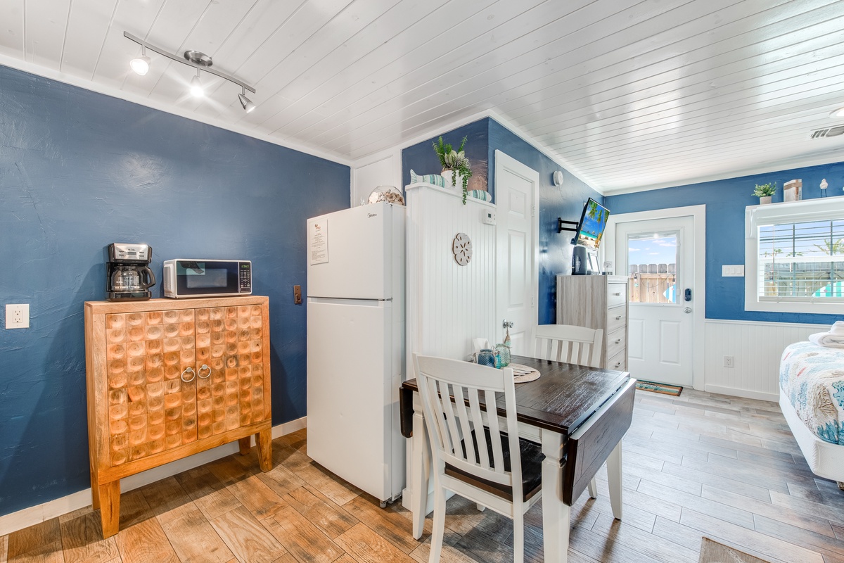 Your charming kitchen nook features everything you need: full-size fridge, microwave, and cozy dining table where you can enjoy morning coffee.