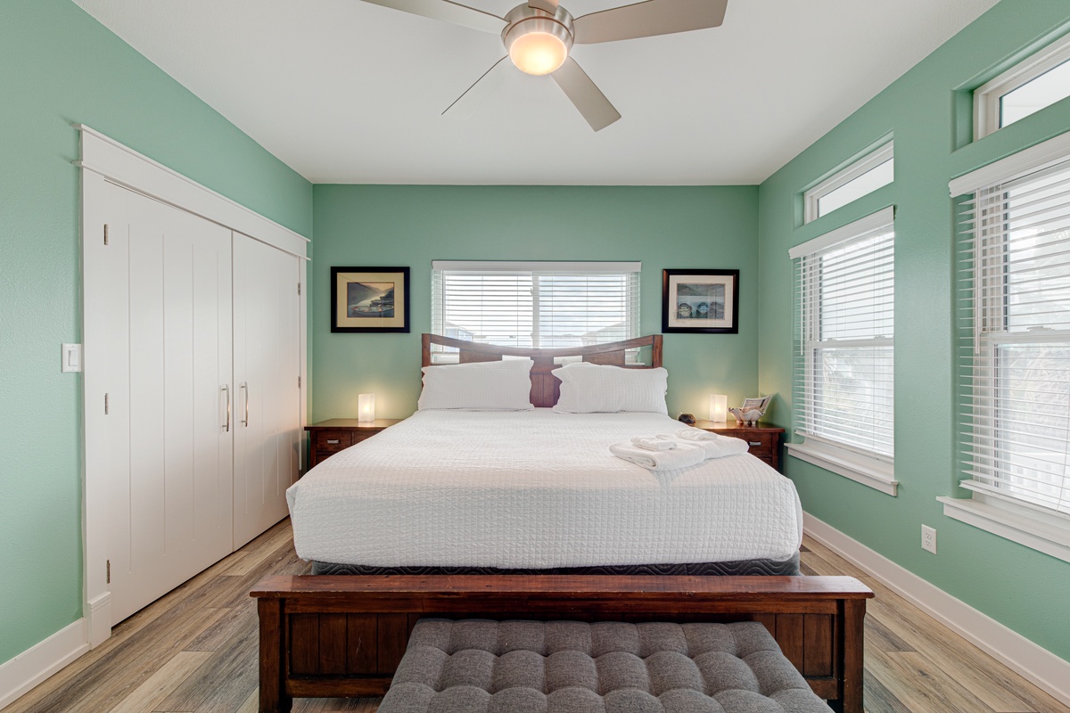 Drift into peaceful sleep in your serene bedroom, where calming mint walls and natural light create your perfect retreat.