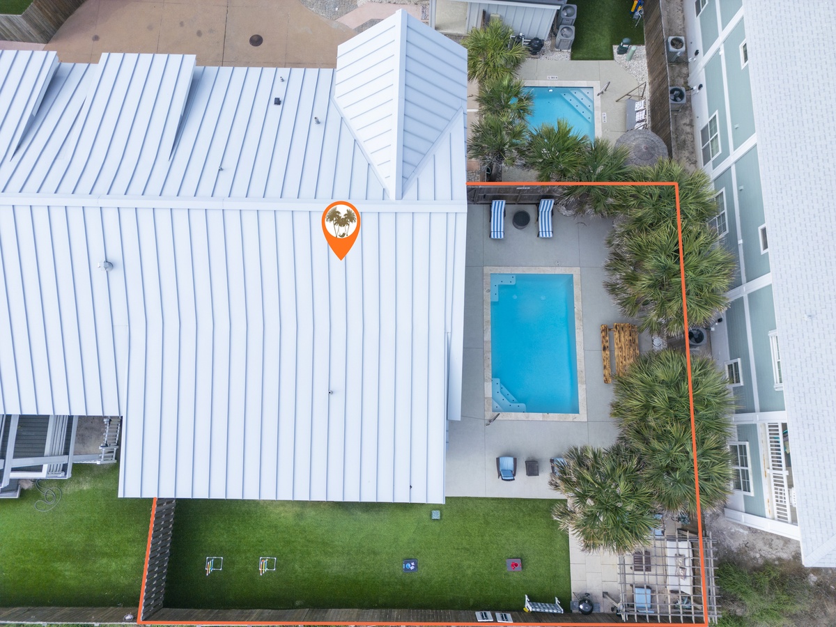 Aerial view of the vacation rental property showing the main building, private swimming pool, and tropical landscaping.
