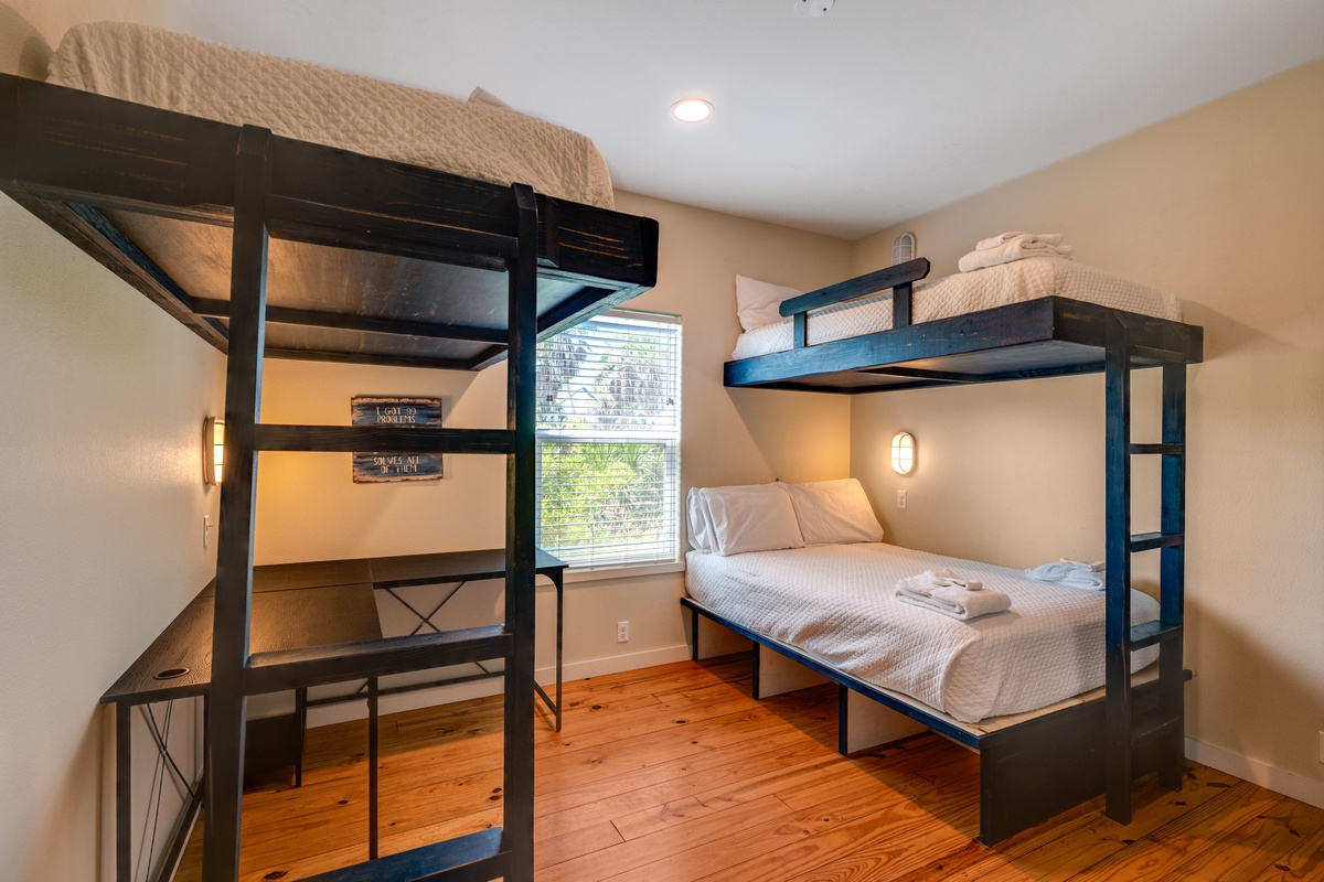 Cozy bunk room with thoughtful lighting creates your perfect shared space retreat with warm wood floors and natural light.