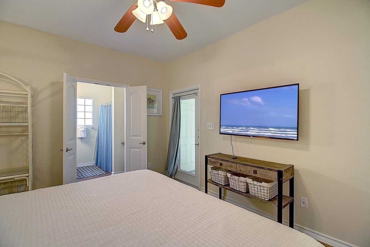 Unwind in your comfortable bedroom with wall-mounted TV for relaxing entertainment after exploring the coast.