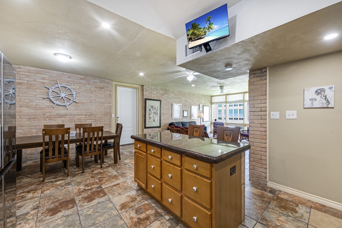 Step into a spacious open-concept living area where coastal charm meets comfort. Enjoy cooking in your well-equipped kitchen island while gathering at the dining table beneath bright, natural light and nautical accents.