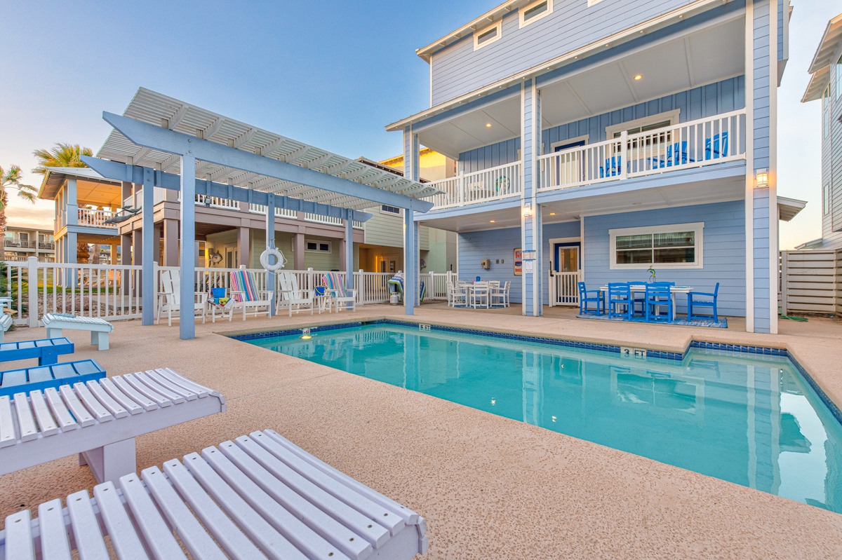 Stunning beachside property featuring a private pool surrounded by tropical coastal architecture and multiple outdoor relaxation areas.