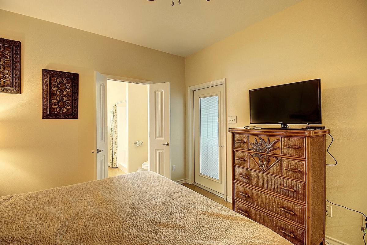 Drift off in your peaceful bedroom, where warm tones and tropical touches create the perfect sanctuary for restful nights.