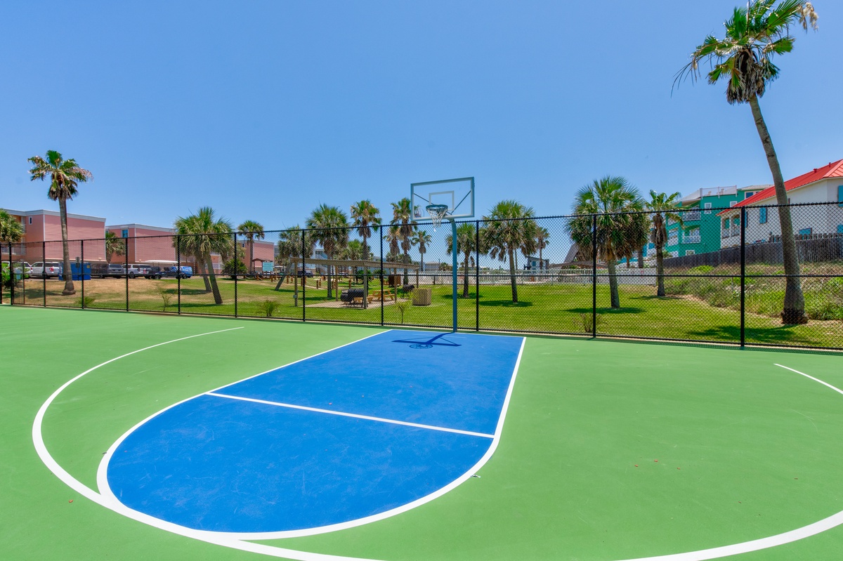Perfect your jump shot on this vibrant basketball court surrounded by swaying palms and tropical scenery.