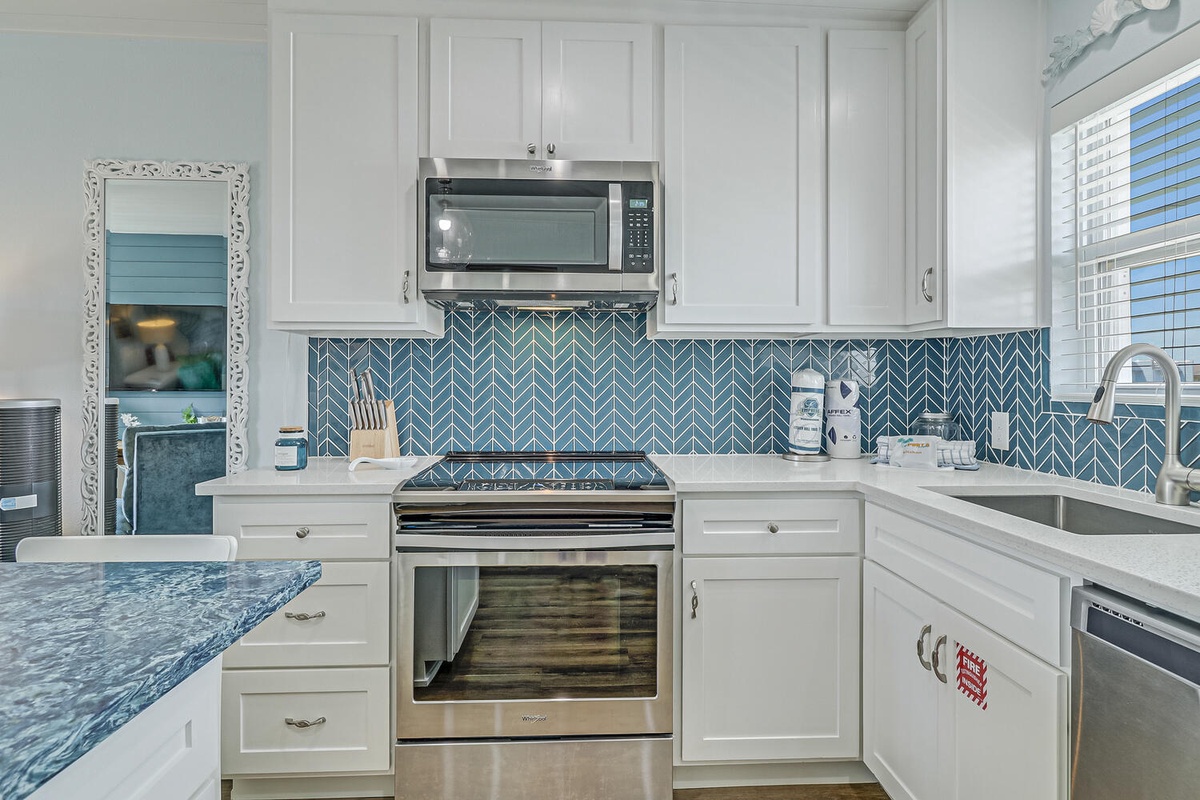 Your fully-equipped kitchen features stunning blue herringbone backsplash, stainless appliances, and everything you need to create memorable vacation meals.