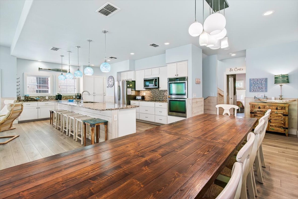 Step into your dream kitchen where coastal elegance meets function. Gather around the stunning wood dining table or chat at the marble island.