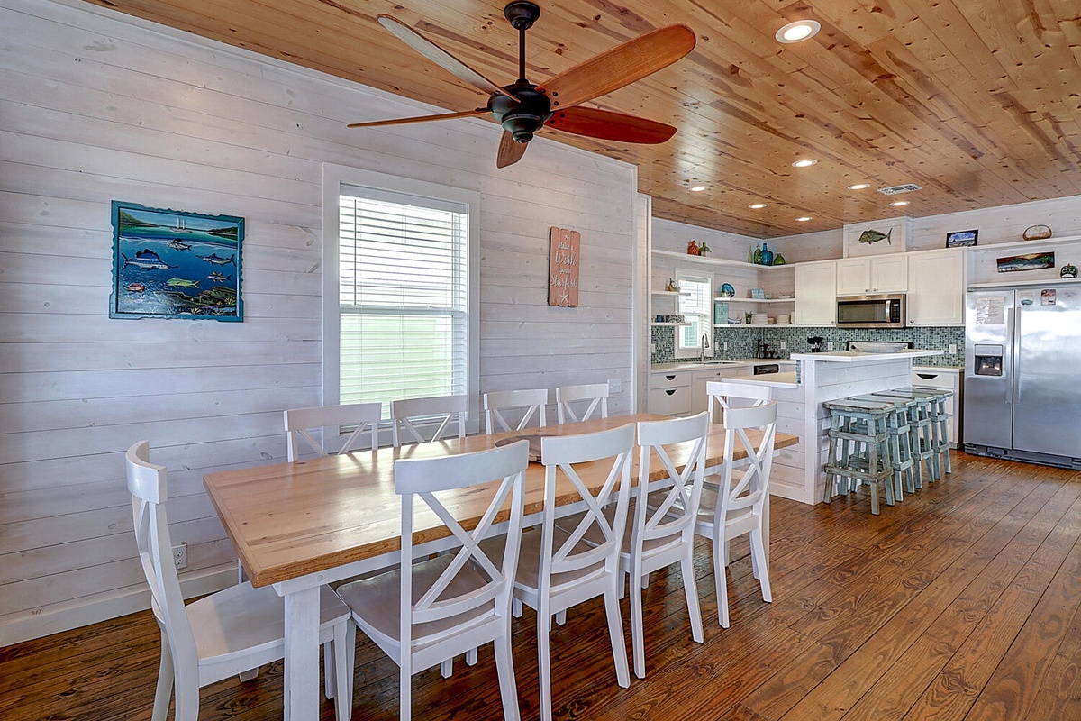Gather your group around this spacious dining table for memorable meals together in this bright, airy coastal-inspired space.