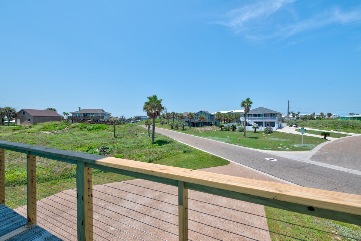 A peaceful coastal neighborhood with palm trees and colorful beach homes, offering a relaxed island atmosphere for your stay.