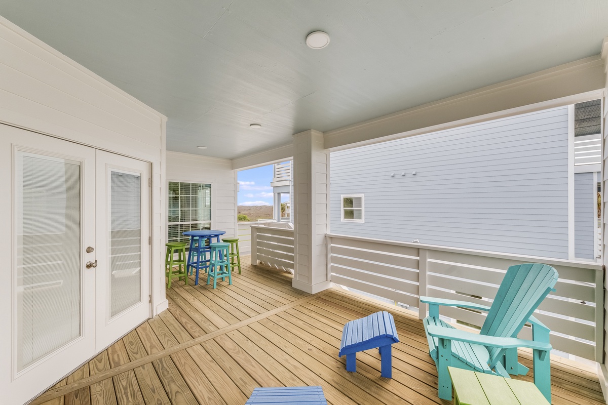 Your private deck offers cozy seating and a high-top table, perfect for morning coffee or evening drinks while enjoying ocean breezes.
