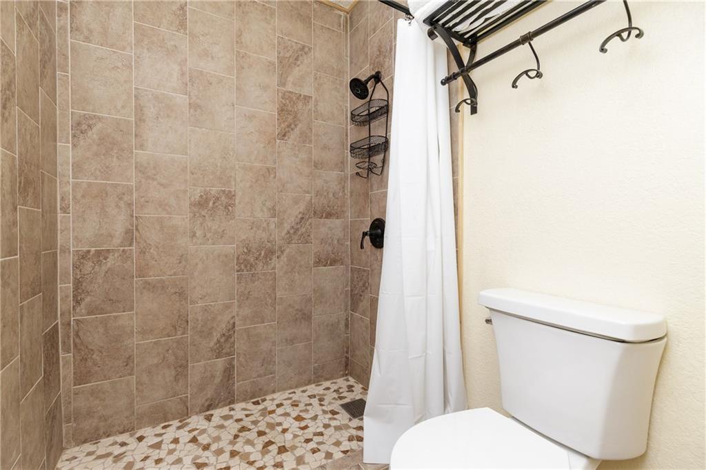 Step into your private spa-like bathroom with beautiful natural stone tiling and a refreshing walk-in shower to unwind after exploring.