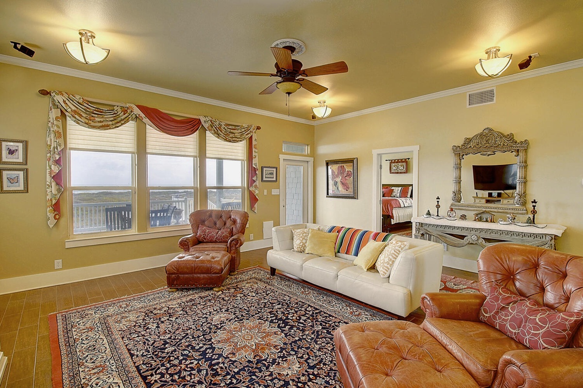 Sink into plush leather chairs and enjoy ocean views from your elegant living room with ornate details and colorful accents.