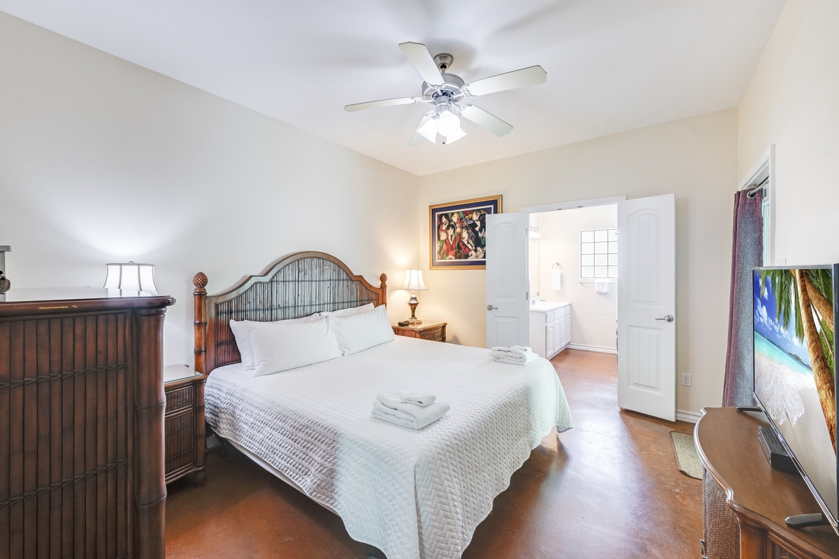Sink into crisp linens and tropical tranquility in your serene bedroom sanctuary, complete with modern comforts and peaceful ambiance.