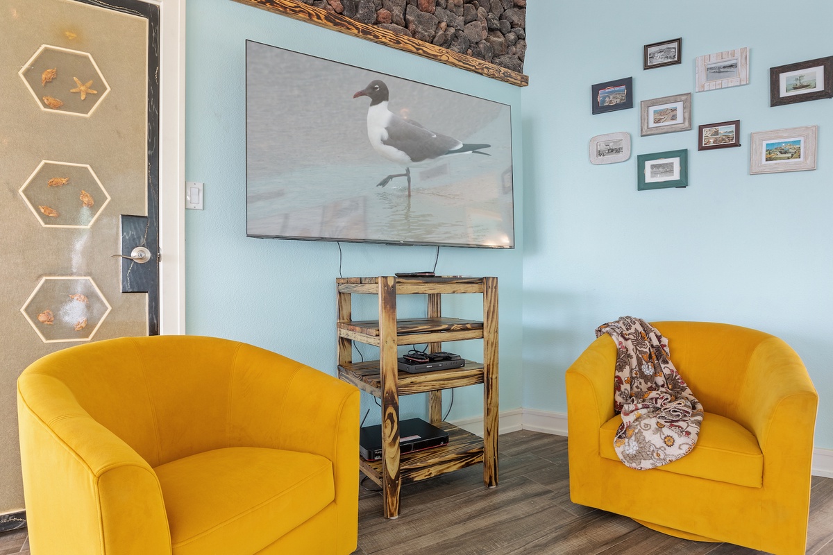 Sink into cheerful yellow armchairs while enjoying coastal artwork and photos on the soft blue walls.
