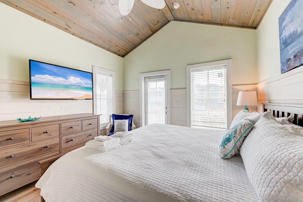 Your peaceful bedroom features crisp linens, warm wood accents, and coastal touches that create the perfect retreat for restful nights.