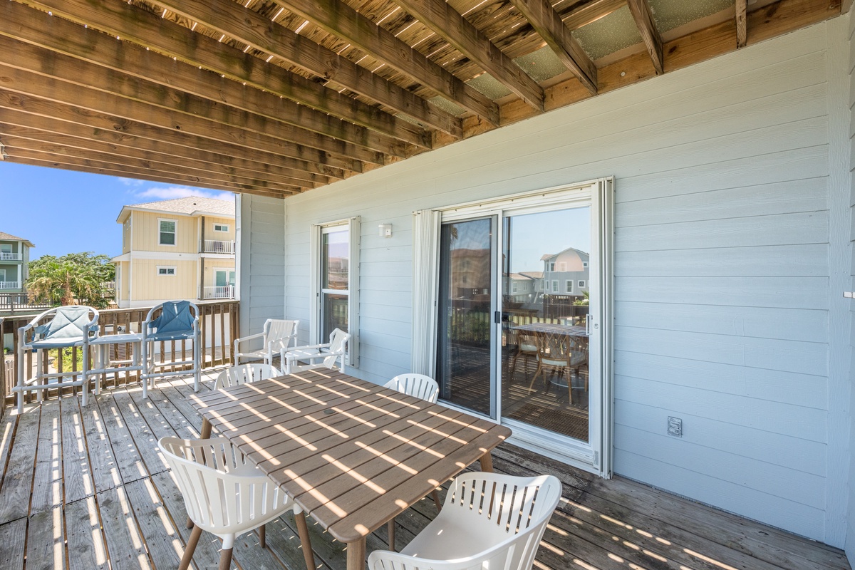Step onto your private deck where morning coffee and evening dinners taste better under the covered wooden beams, with neighborhood views stretching beyond.