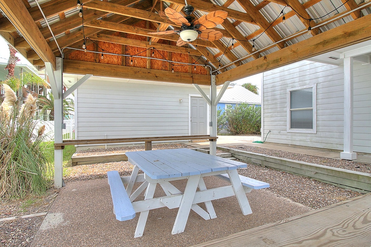 Your private covered patio offers the perfect spot to enjoy meals outdoors with a picnic table and tropical ceiling fan overhead.