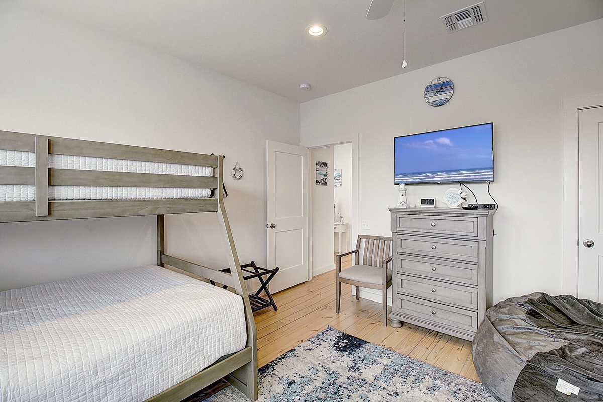 Settle into your comfortable bunk bed room with ocean views on TV, perfect for family getaways with cozy linens and thoughtful touches.