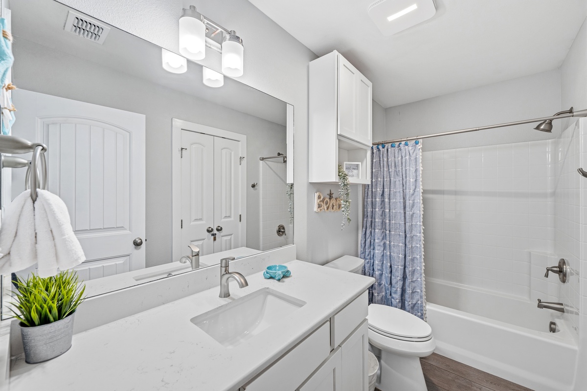 Step into your bright, spotless bathroom where every detail is just right—fresh towels, a soothing tub, and plenty of space to unwind after a day of adventure.