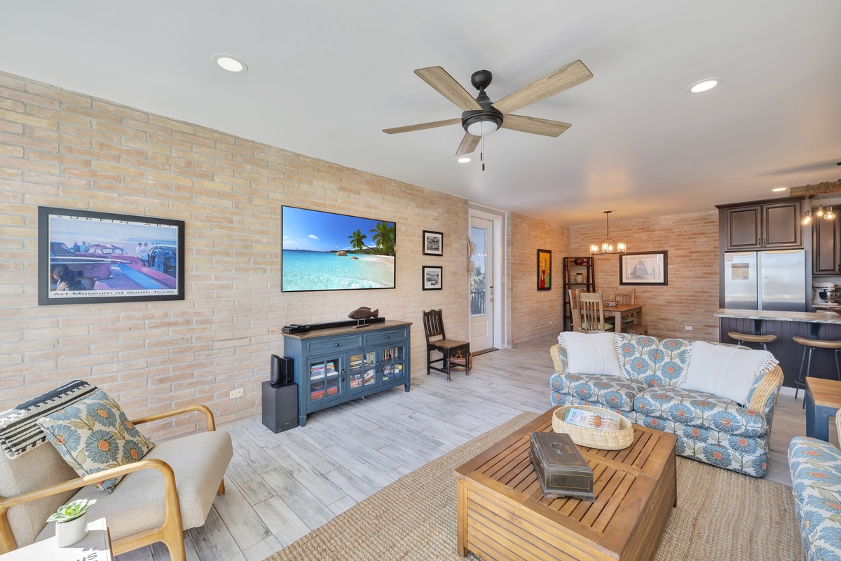 Relax in your open-plan living space with coastal comfort—plush seating, modern entertainment, and a seamless flow to the fully equipped kitchen.