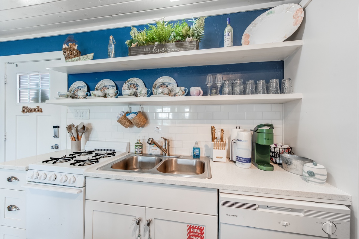 Your charming kitchen features open shelving displaying beautiful dishes, a gas stove for cooking adventures, and thoughtful touches that make it feel like home.