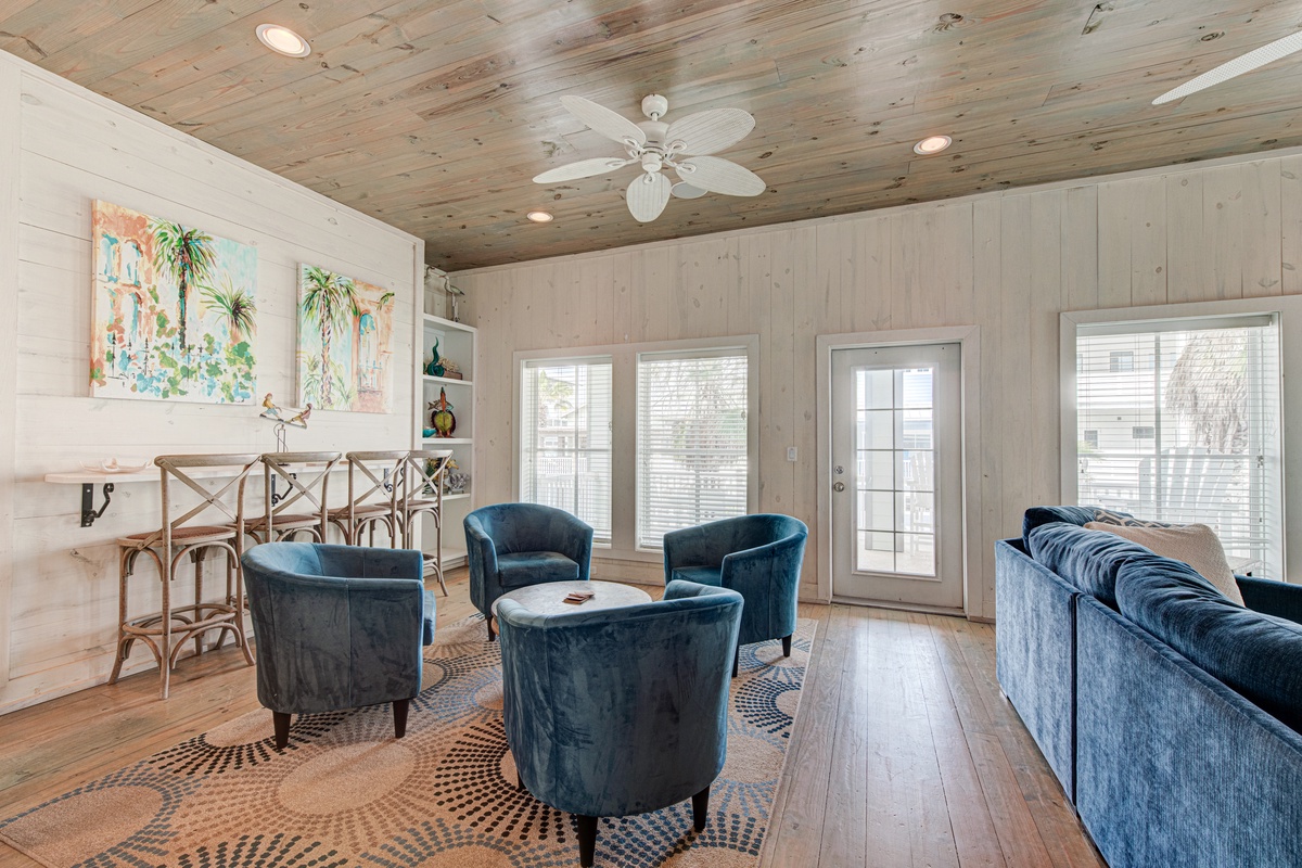 Relax in your coastal haven where plush navy velvet seating and reclaimed wood create the perfect blend of comfort and beach style.