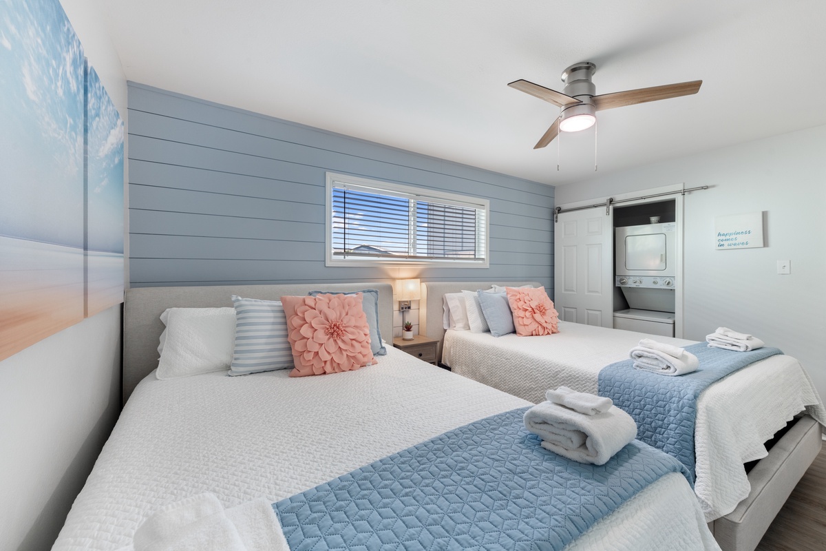 Drift off in your serene coastal bedroom with soft linens and gentle ceiling fan breeze creating the perfect restful retreat.