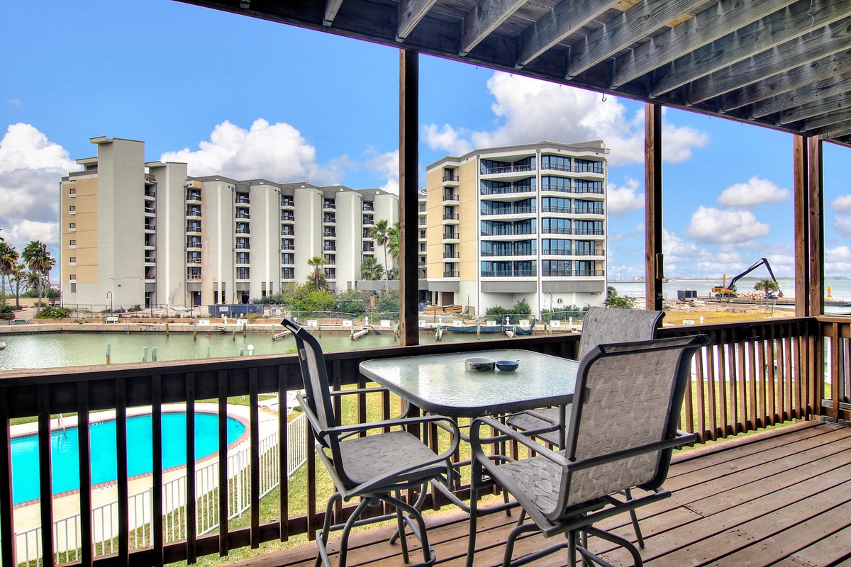 Relax on your private covered balcony with waterfront views, perfect for morning coffee while watching boats glide by the marina.