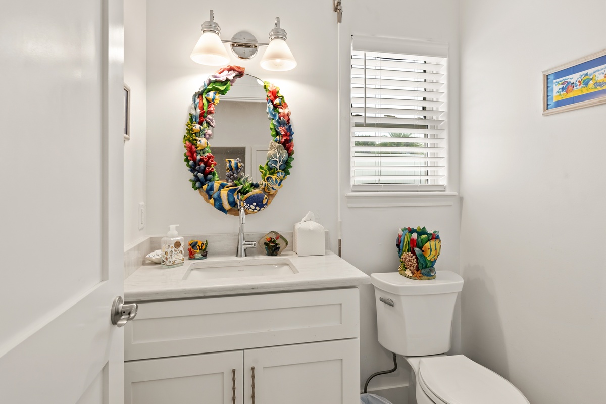 Clean and bright, this bathroom offers everything you need with a cheerful coastal touch—charming décor adds personality to your space.