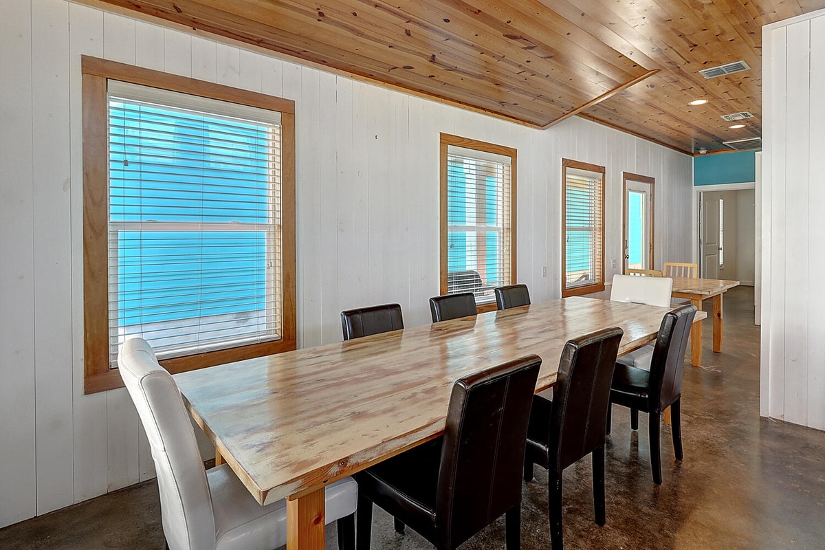 Gather around this spacious dining table with stunning water views filtering through your windows, perfect for memorable meals together.