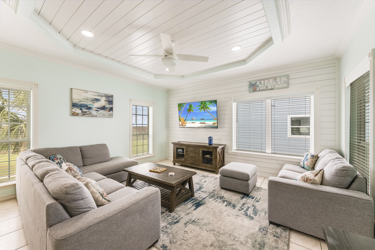 Sink into plush seating and unwind in this bright living room with coastal charm and modern comfort.