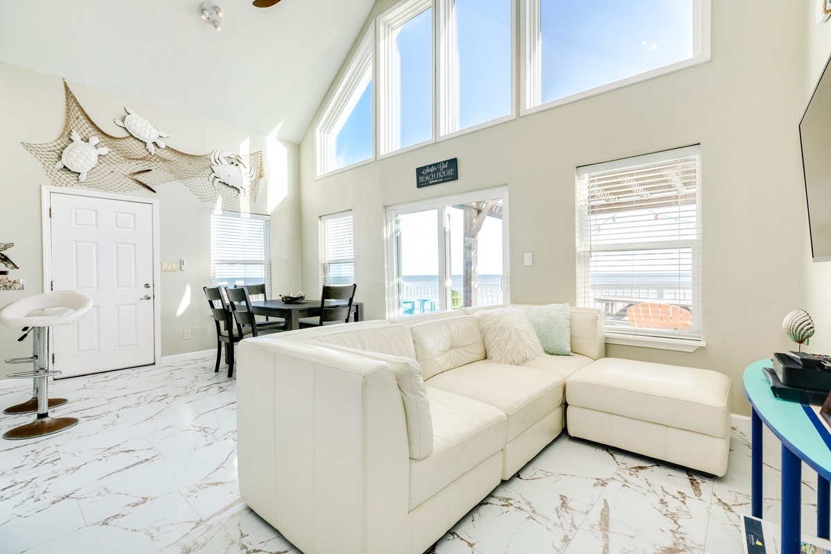 Bright & airy living area, windows frame the Gulf