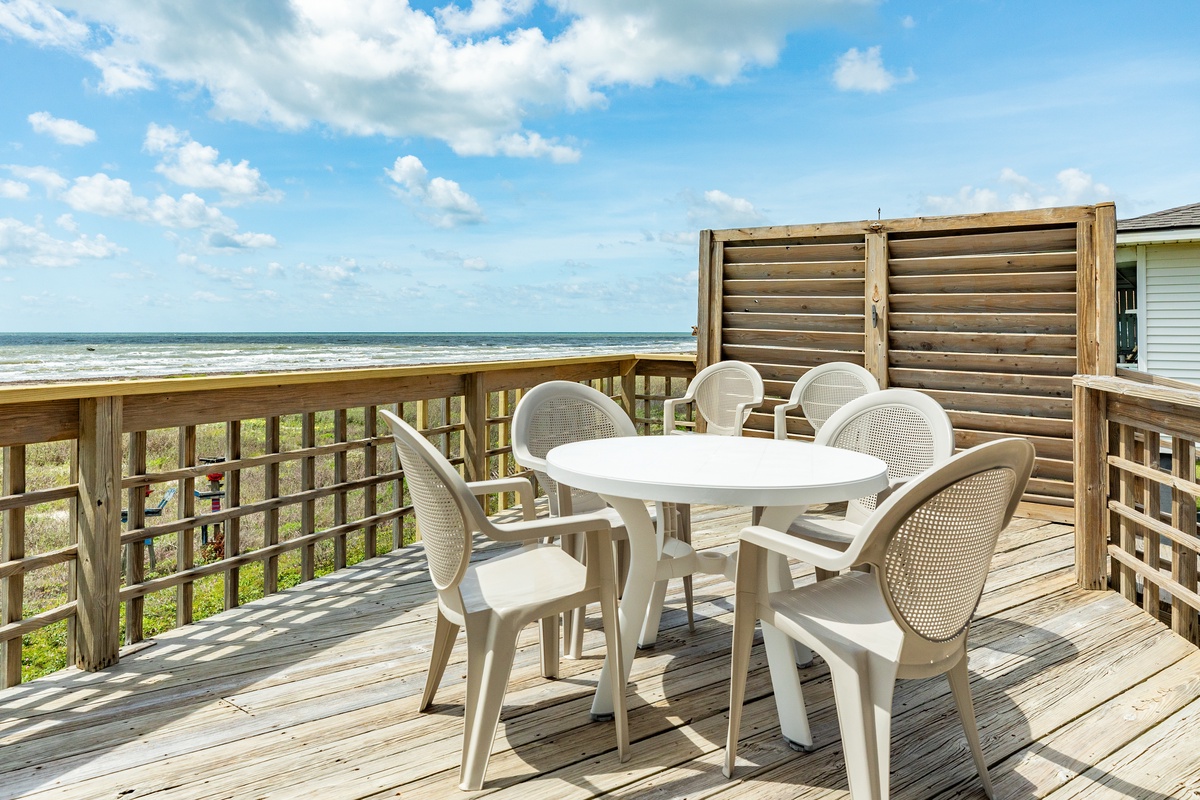 Dine al fresco and watch dolphins swim in the surf