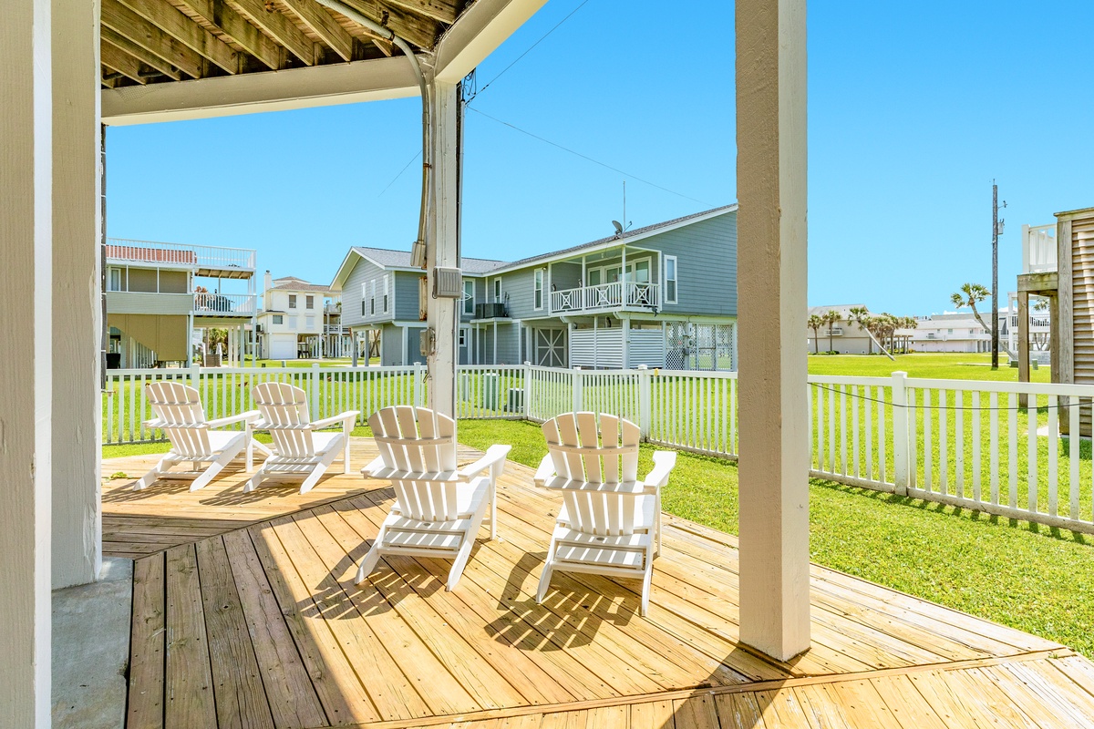 Relax in the Gulf breezes on the partially covered ground level patio