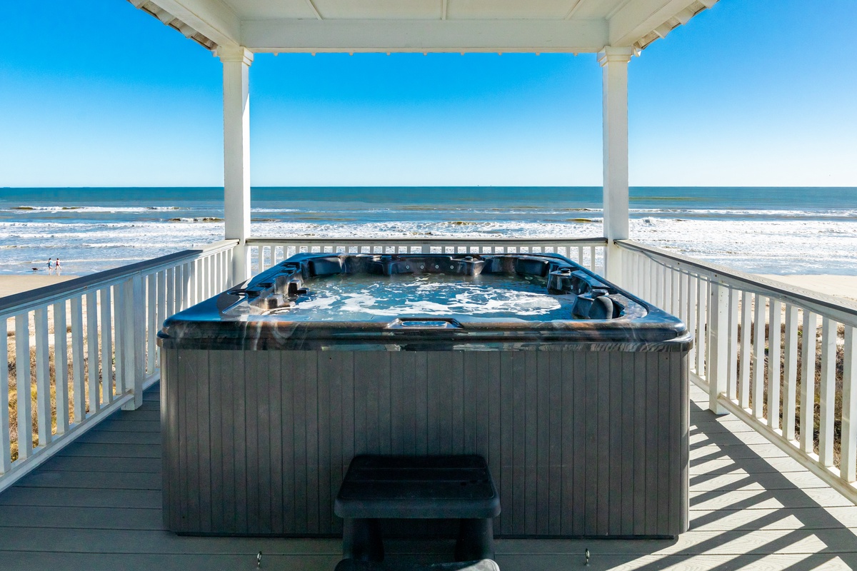 Unwind after a day in the sun in the private hot tub overlooking the Gulf