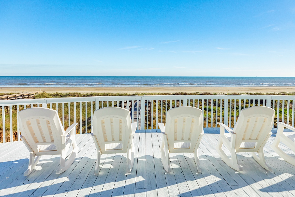 Watch the dolphins swim in the surf from the expansive deck