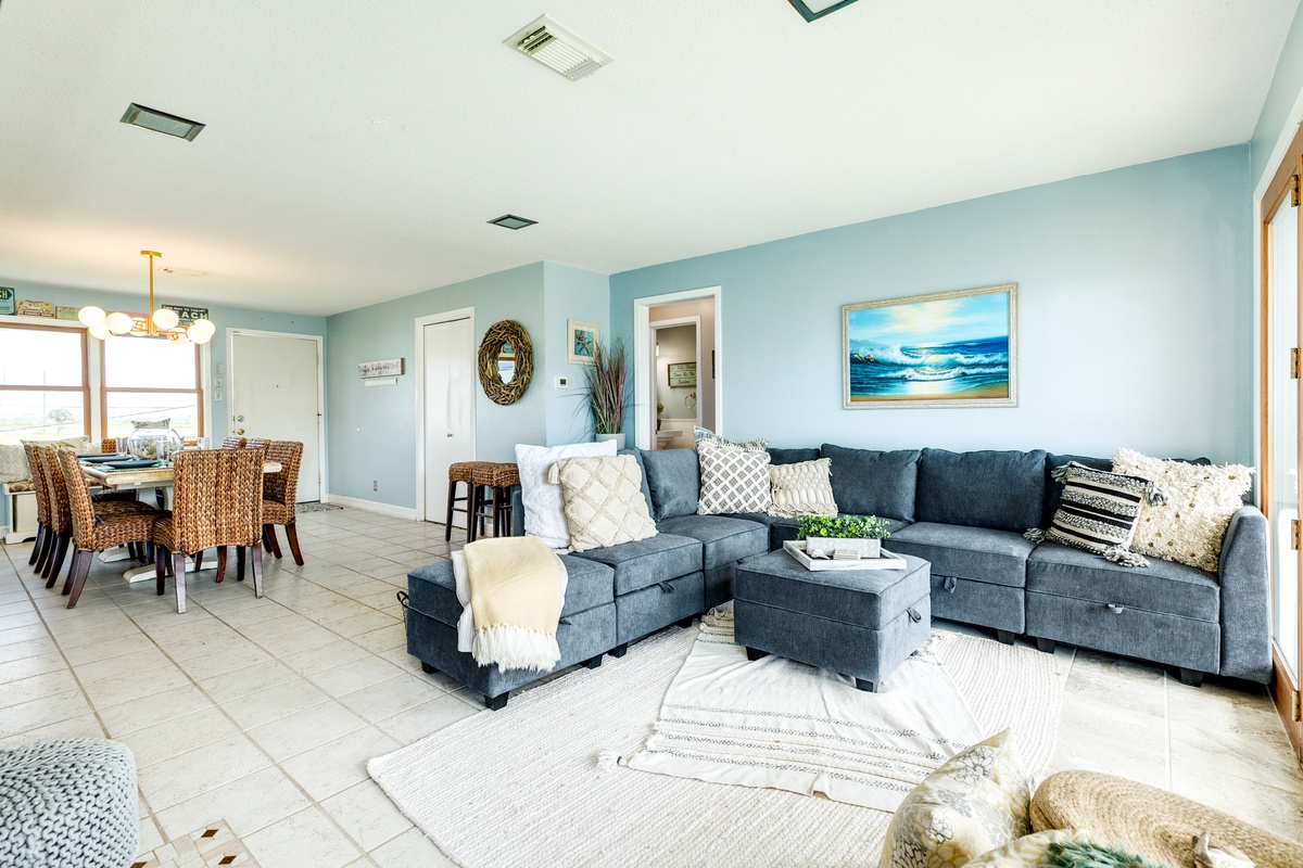 Open living area with large comfortable sectional and nearby dining