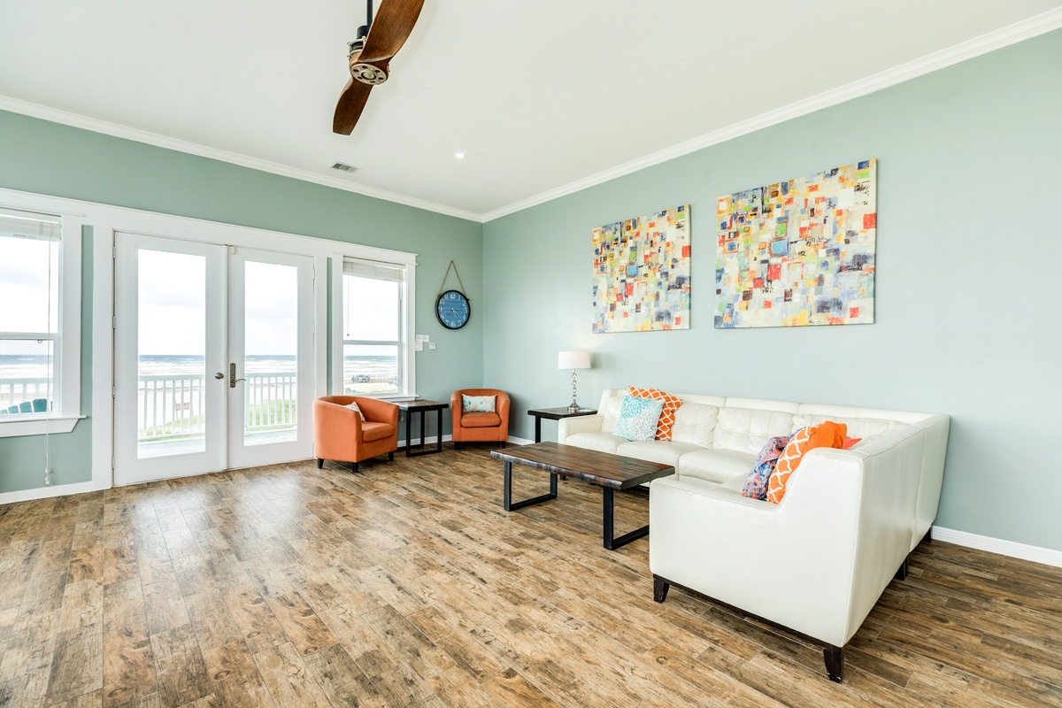 Bright and airy living room with windows showcasing the Gulf views