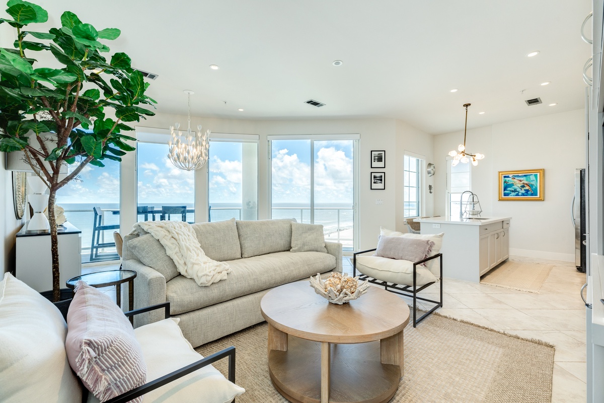 Bright and open living area with wall of windows showcasing the Gulf views