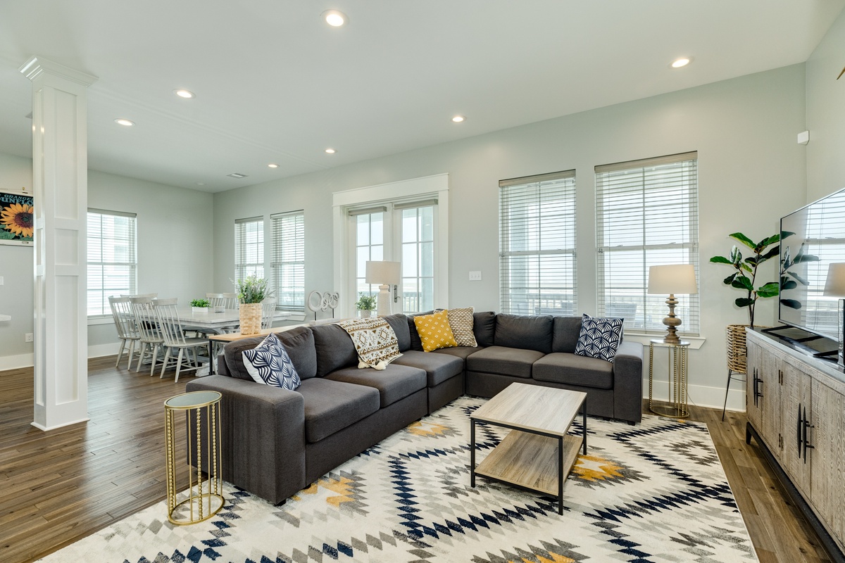 Bright & airy living room with large windows showcasing Gulf views